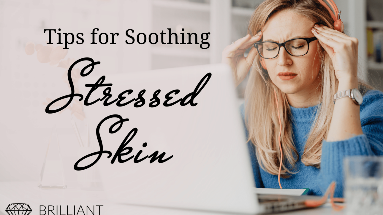 White girl in blue sweat shirt and eye glasses holds her temple with closed eyes: text: tips for soothing stressed skin
