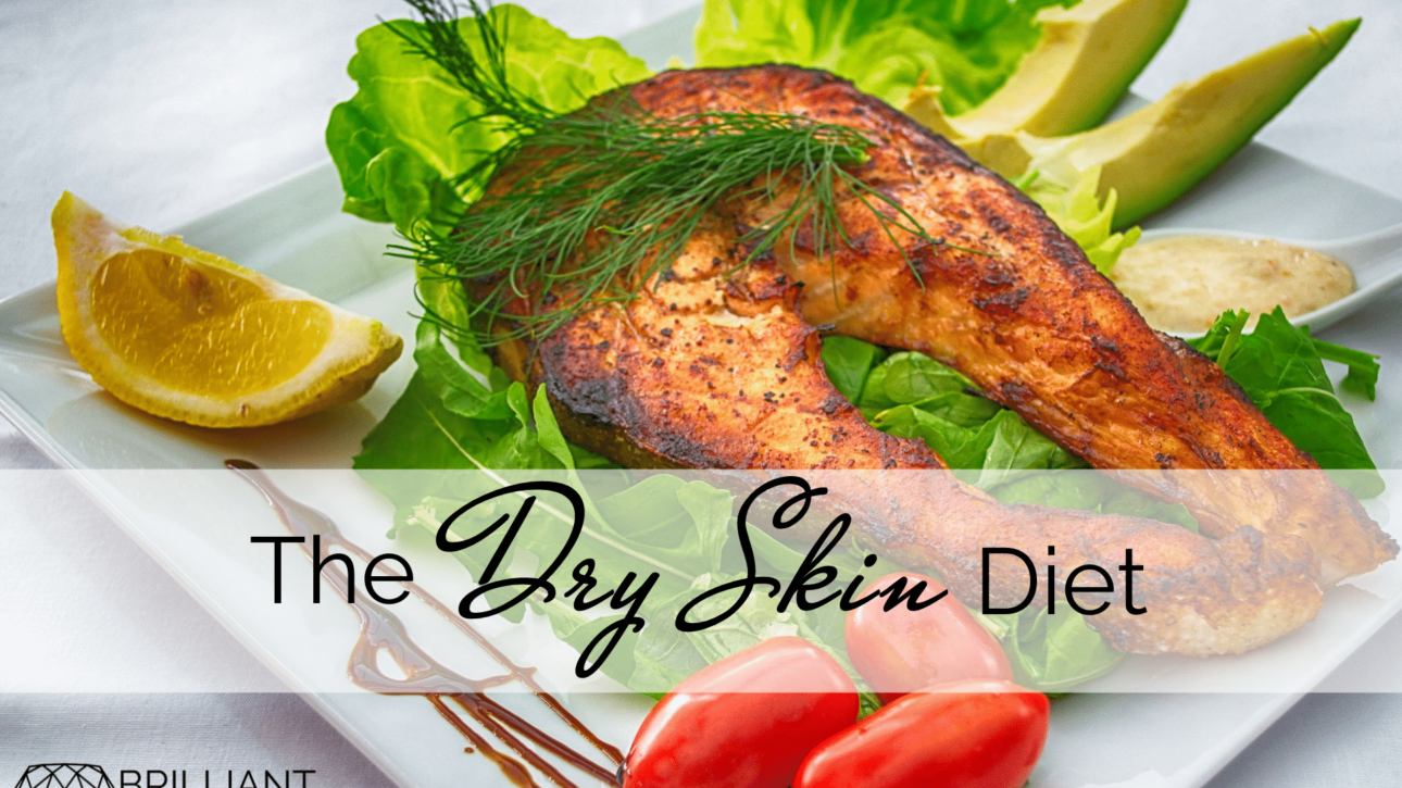 healthy foods like tomatoes, lemon, avocado, green leafy vegetables and fish on plate; text; the dry skin diet