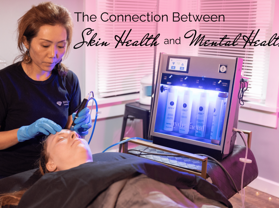 a licensed esthetician in black uniform giving a Hydrafacial to a client lying in a facial bed: text: the connection between skin health and mental health